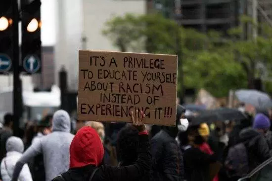 A protester holding a banner saying 