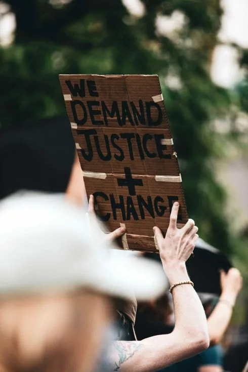 A protester holding a banner saying 