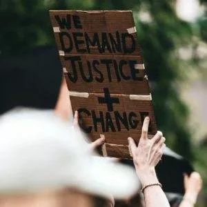 A protester holding a banner saying 